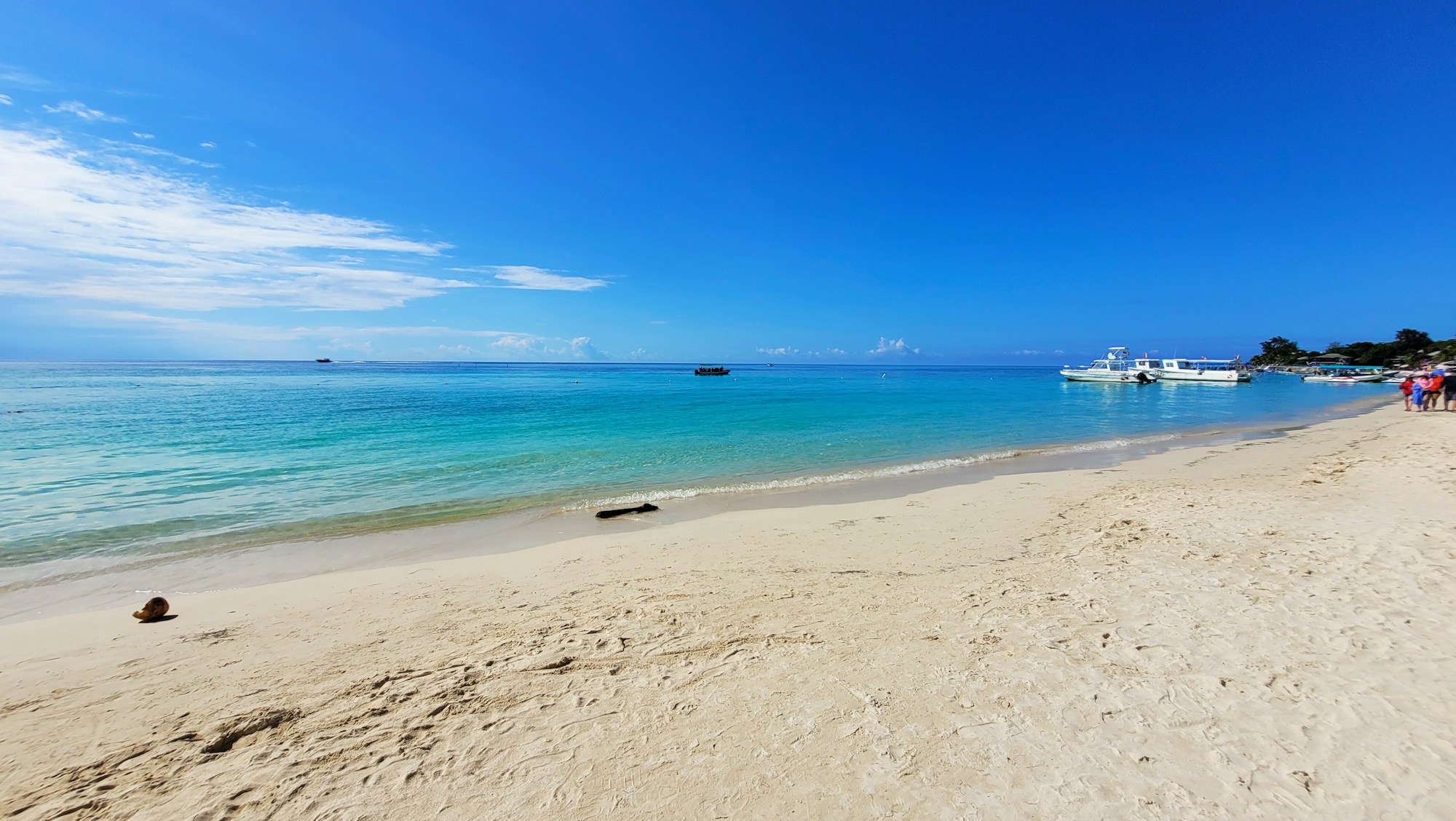 Roatan West Bay beach with turquoise water and wooden pier