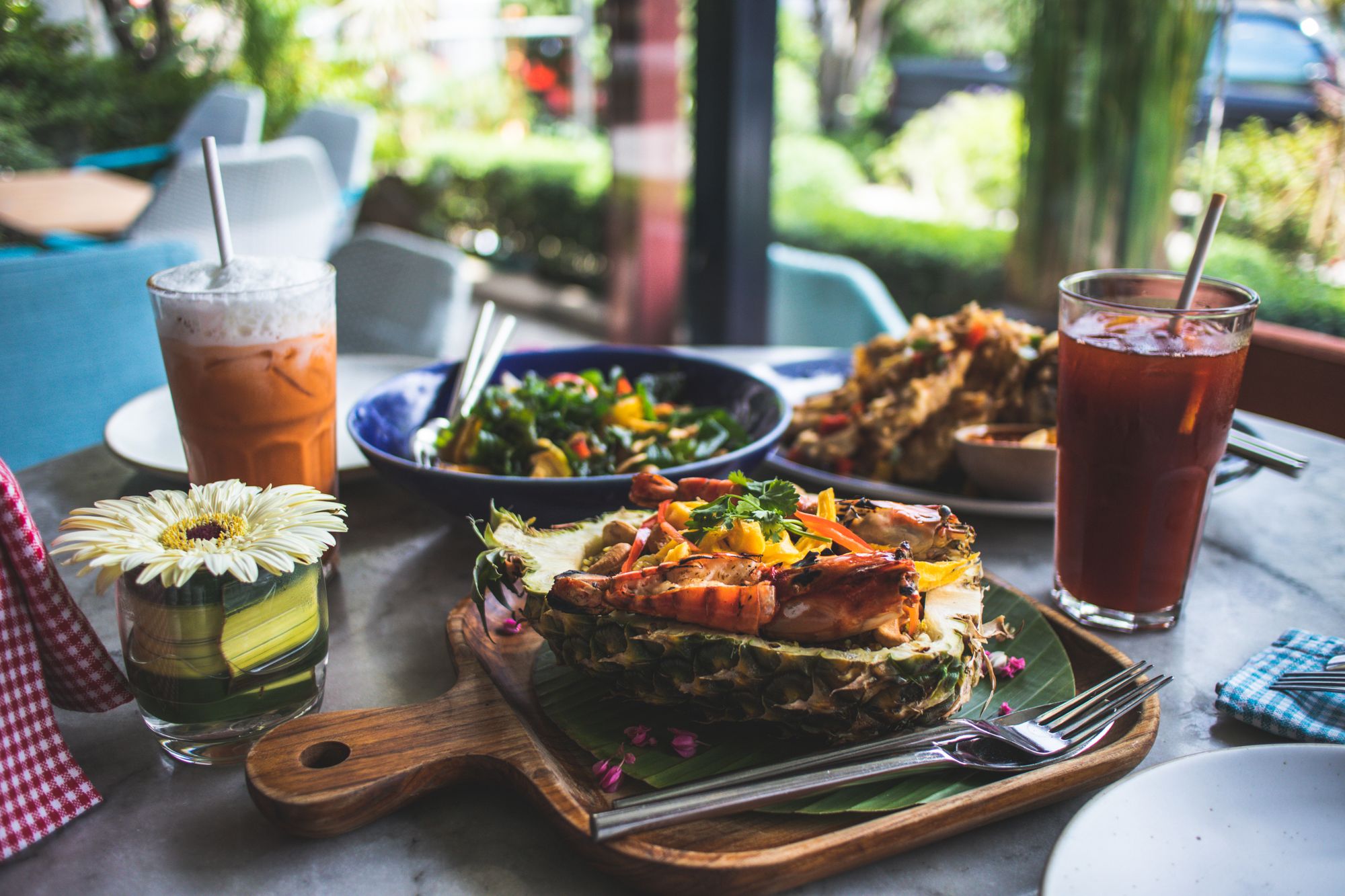 Tropical seafood dining experience with fresh lobster and floral garnish