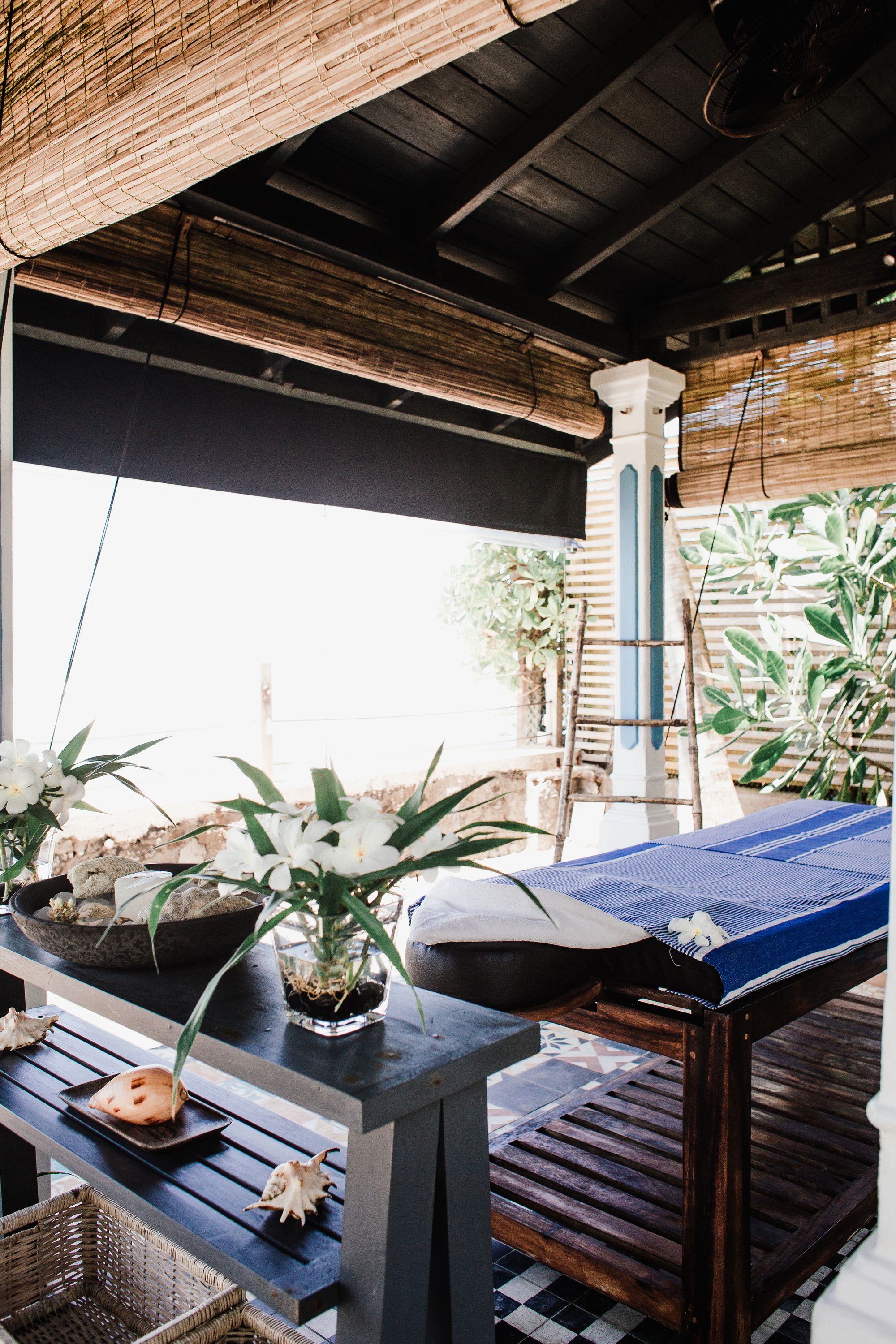 Outdoor spa gazebo with tropical decor and massage table