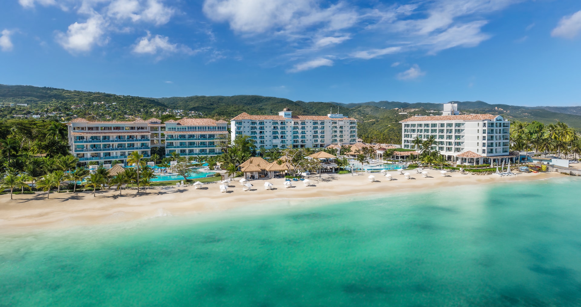 Couple reviewing airport transfer options with Sandals representative