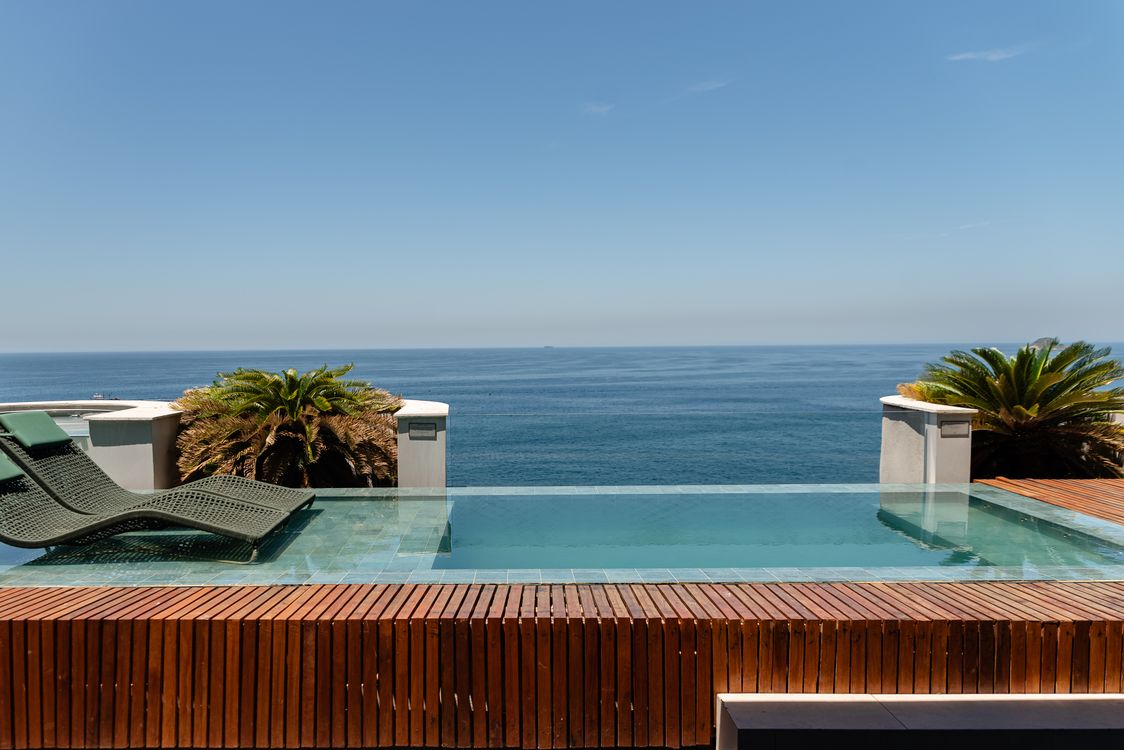 Elegant infinity pool overlooking the ocean at a luxury tropical resort