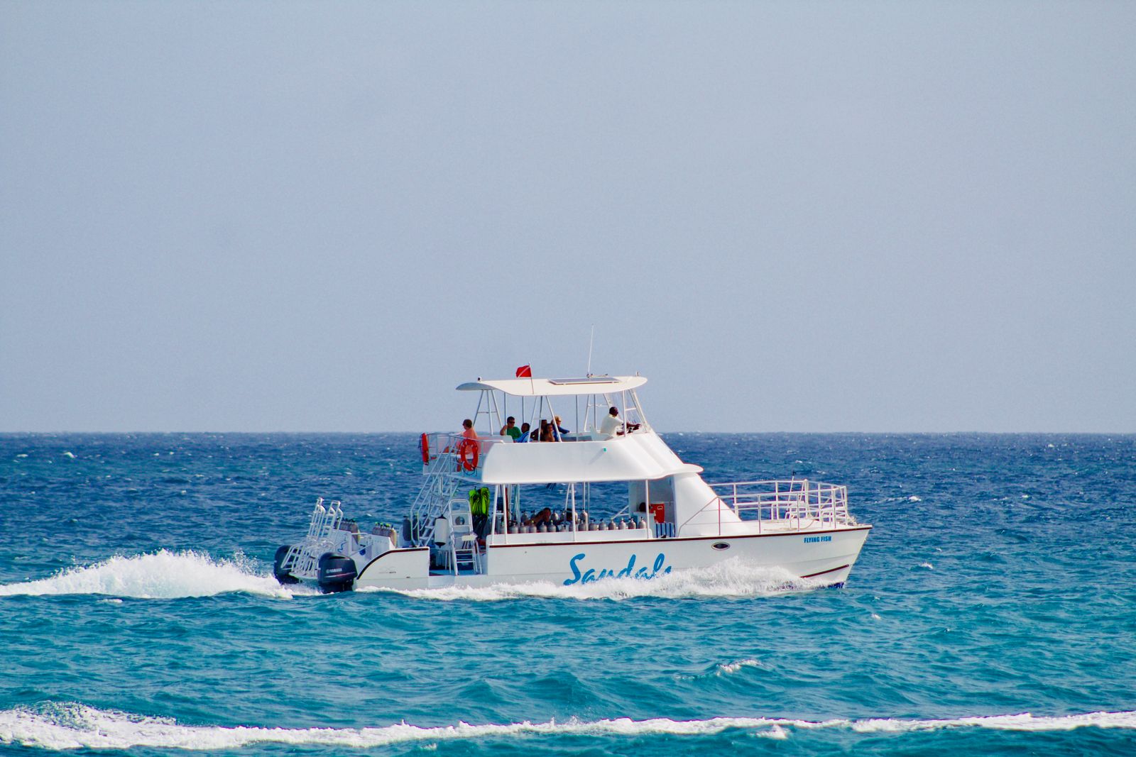 Catamaran anchored in turquoise Carlisle Bay with Bridgetown in the distance