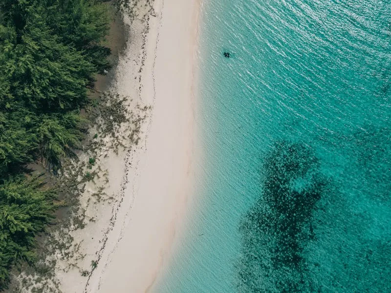 Sandals butler service staff attending to couple's beach setup