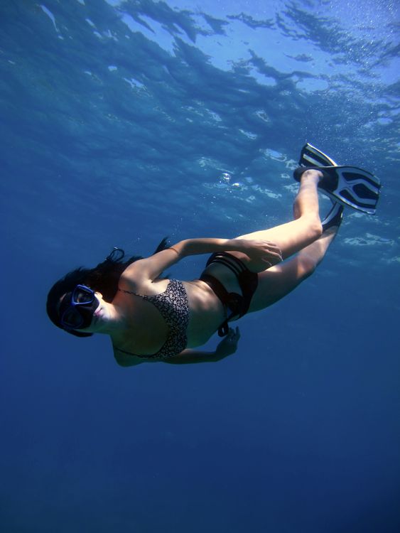 Snorkeler exploring clear blue Caribbean ocean waters