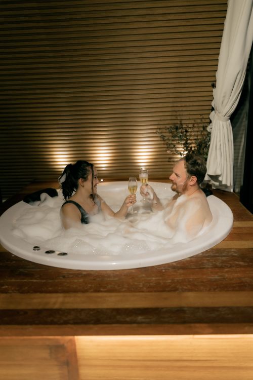 Romantic evening in a luxurious bubble-filled hot tub with champagne