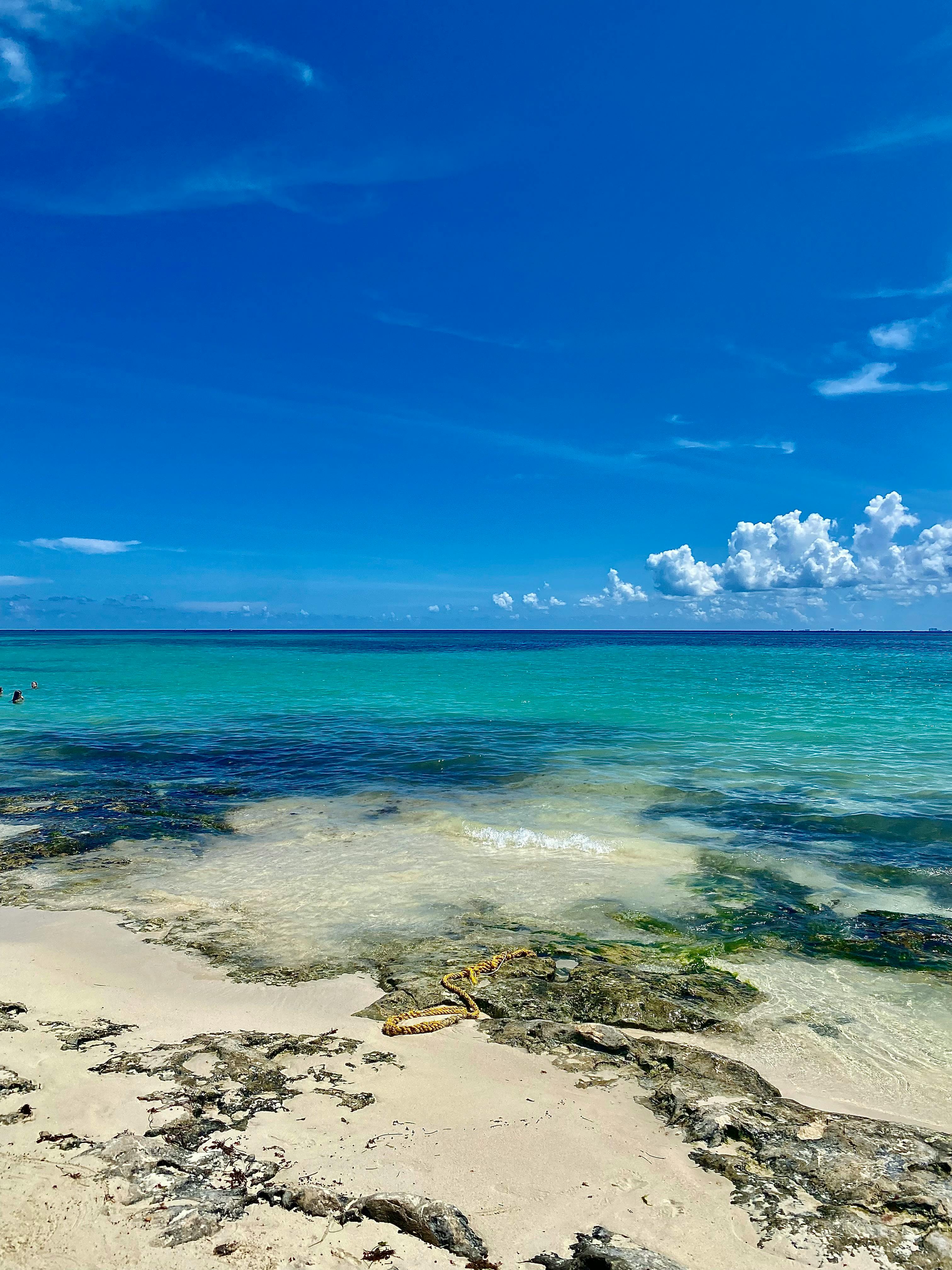 Aerial view of a turquoise Caribbean beach with white sand and gentle waves — the kind of setting couples dream of for a honeymoon all-inclusive.