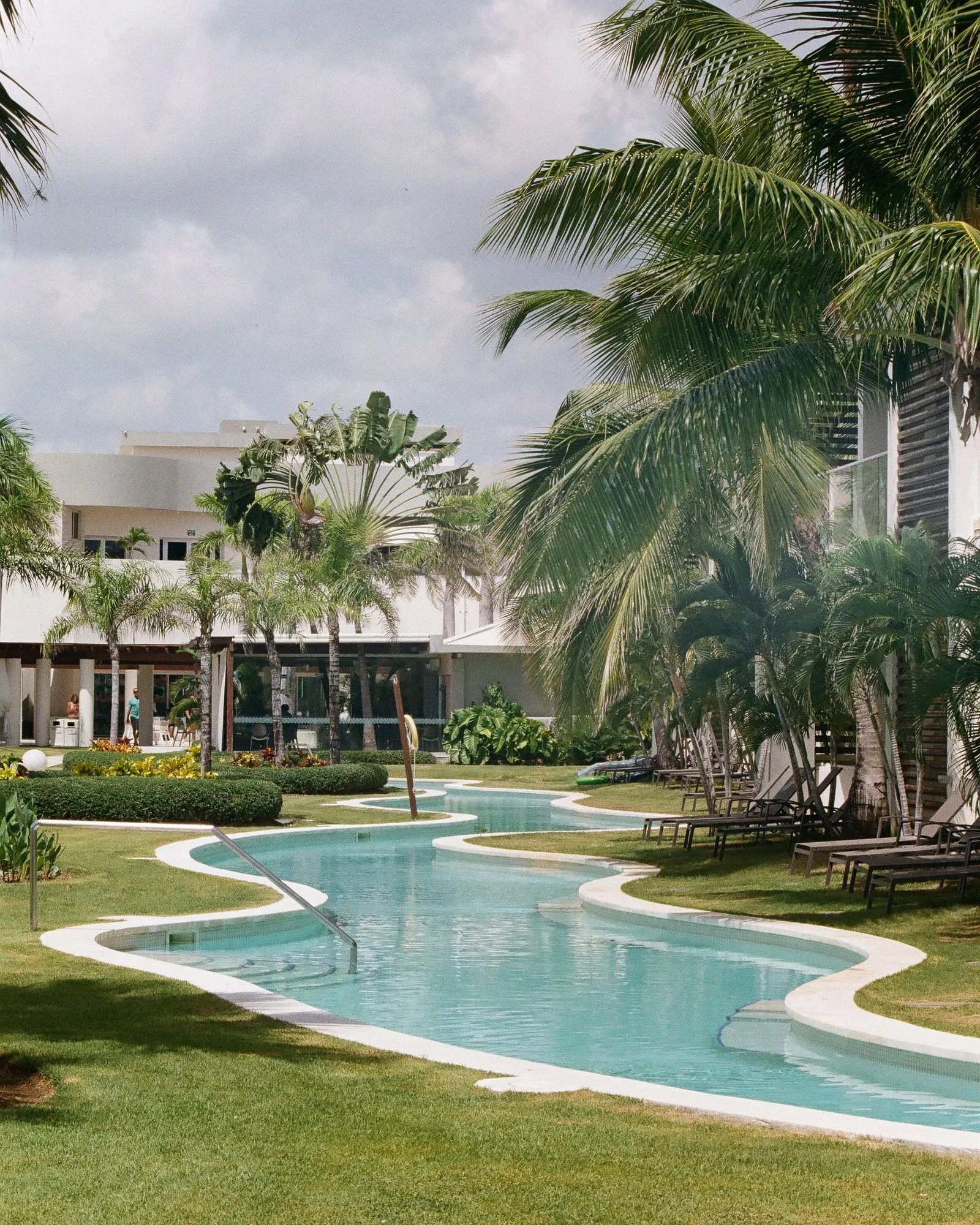 Sandals resort pool complex with guest enjoying morning swim