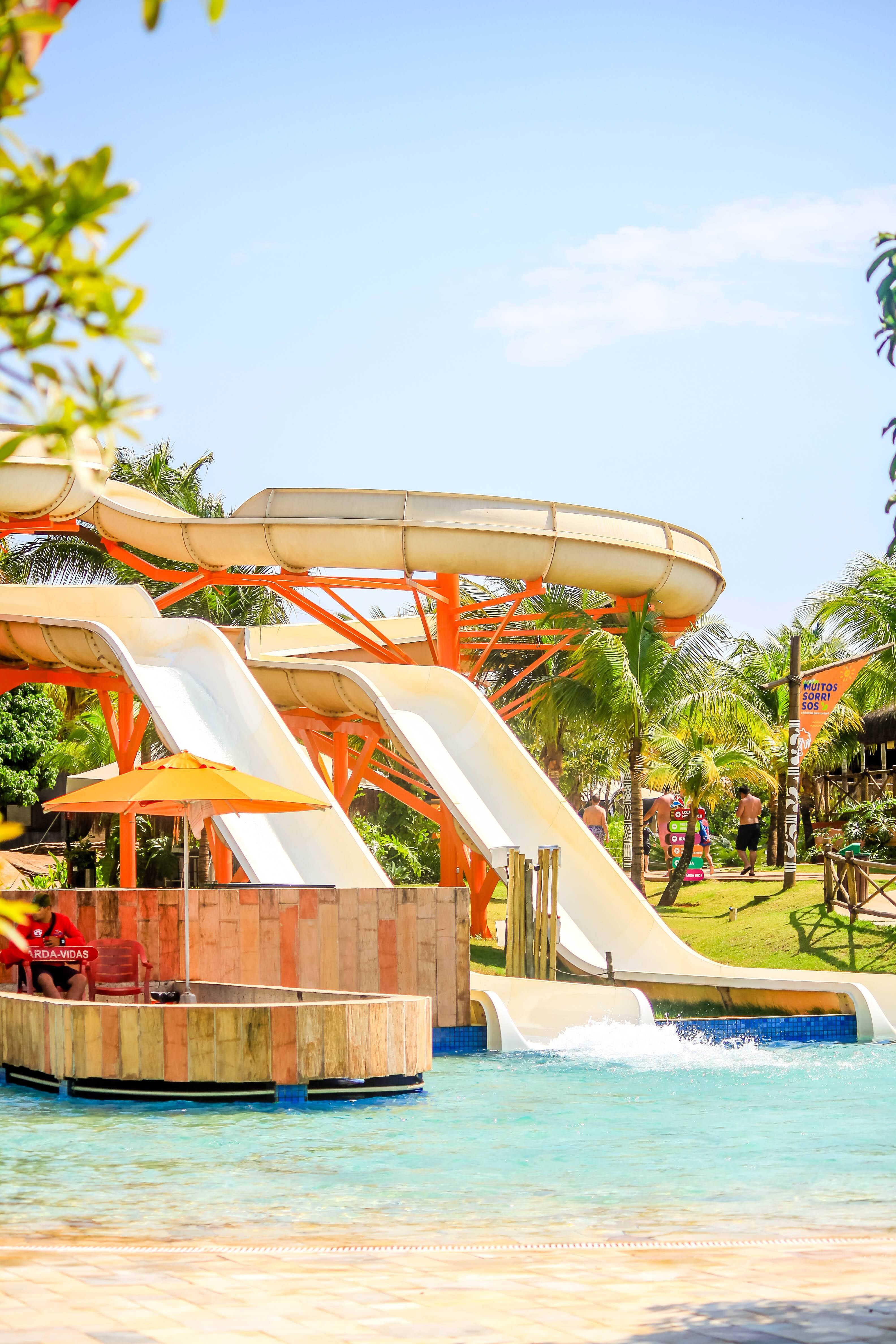 Teens enjoying a surf simulator at a water park.