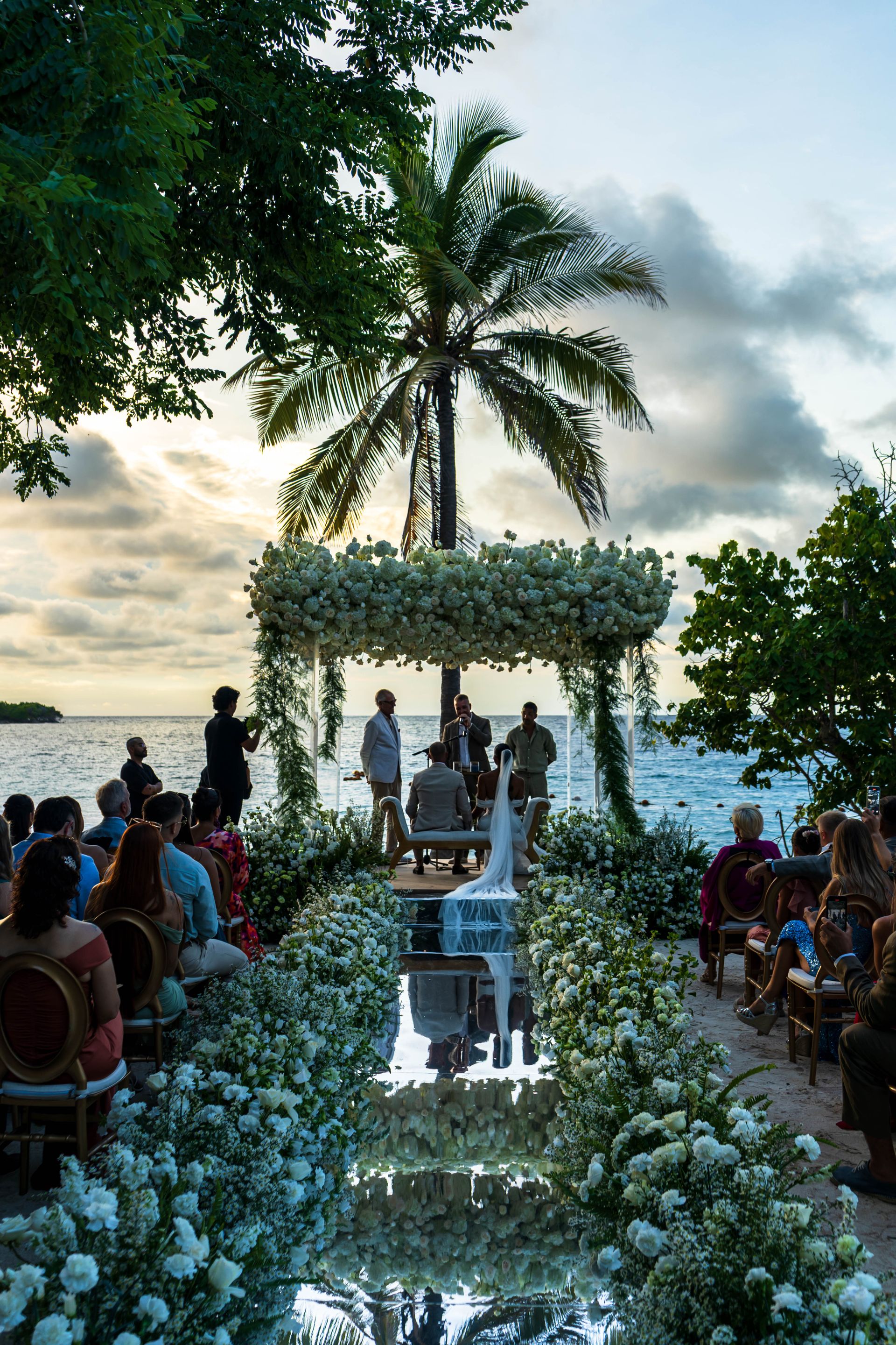 Tropical beachside wedding ceremony at sunset