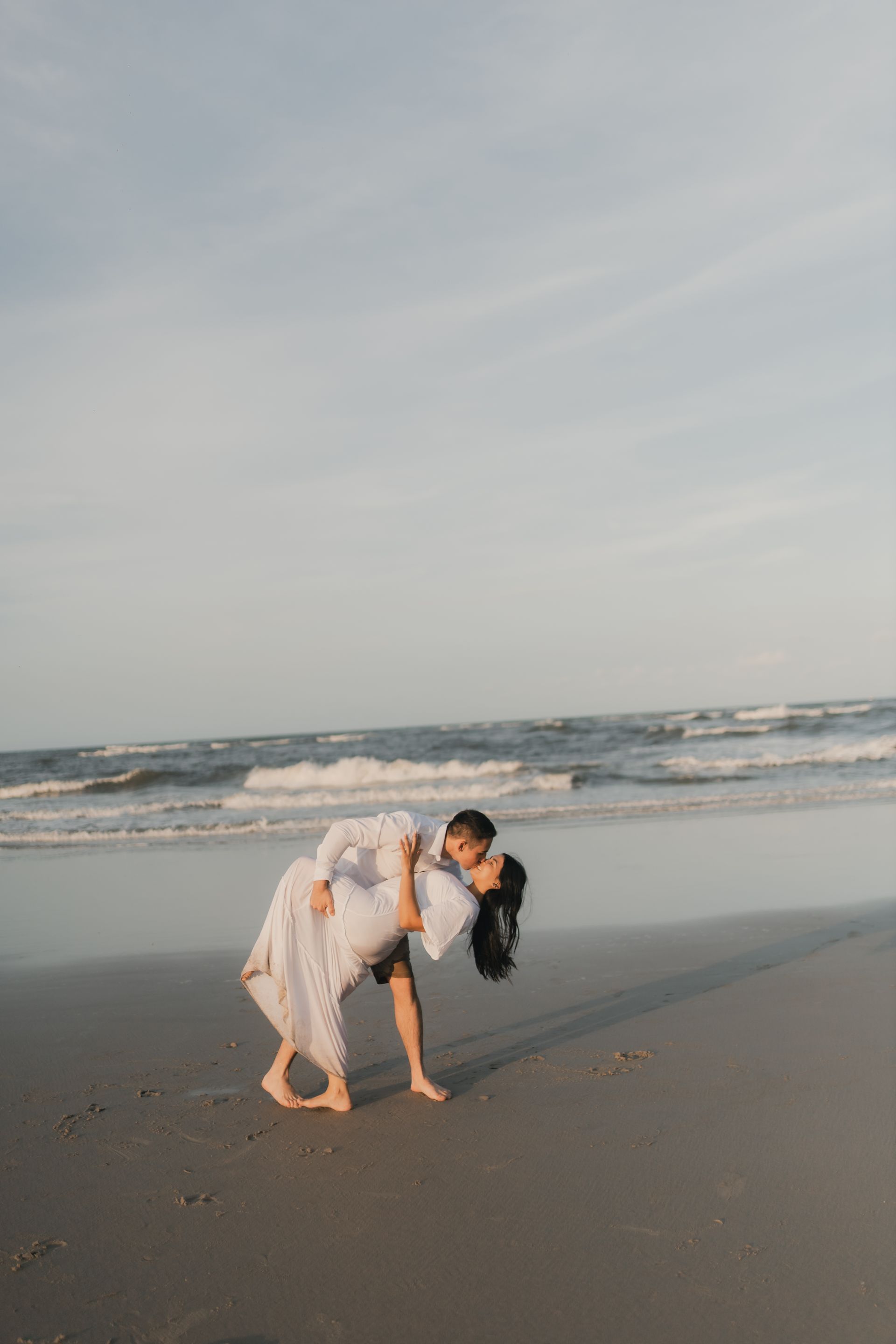 Couple dancing on a tropical beach at sunset