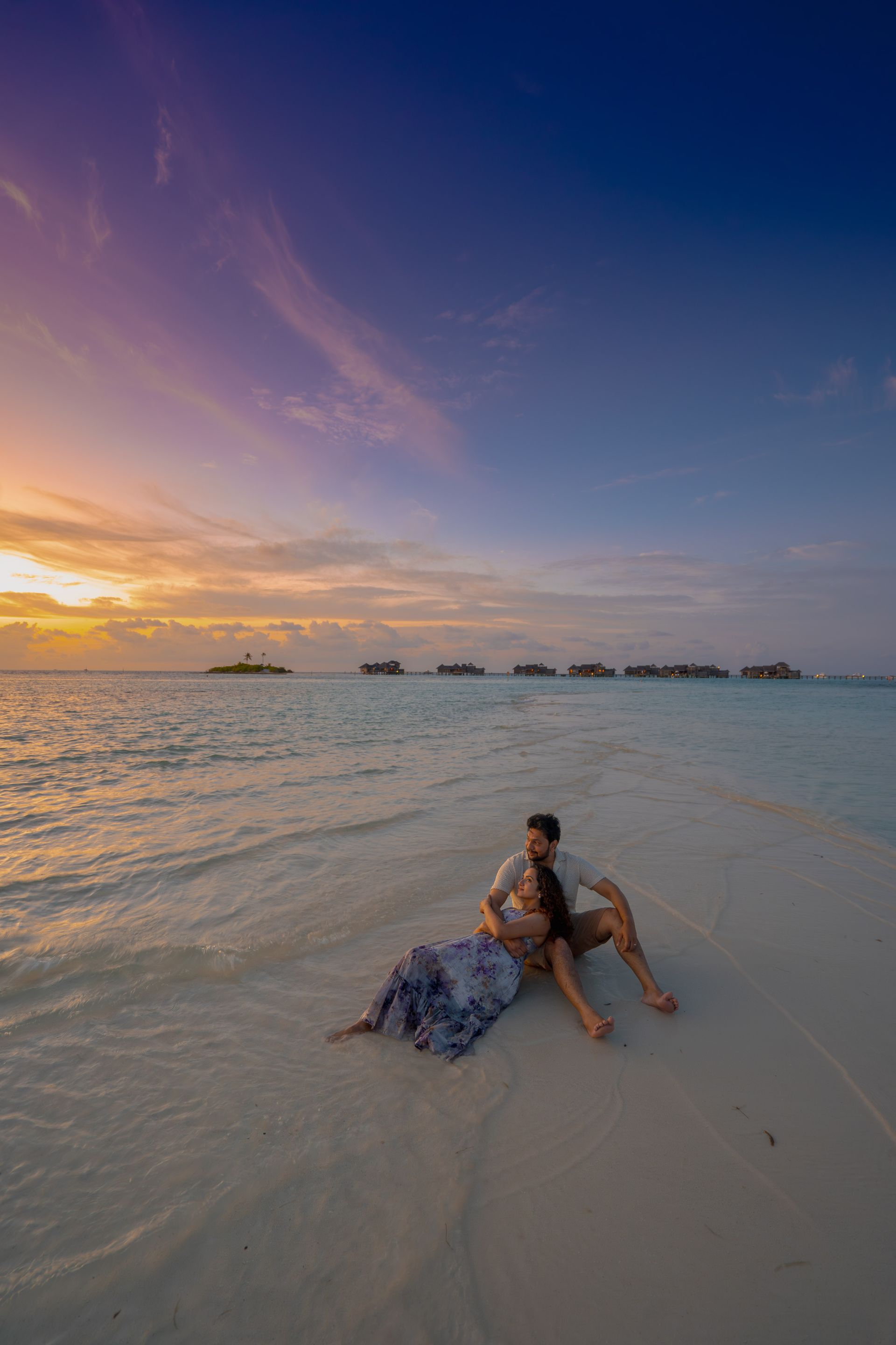 Romantic couple embracing on the beach during a stunning sunset