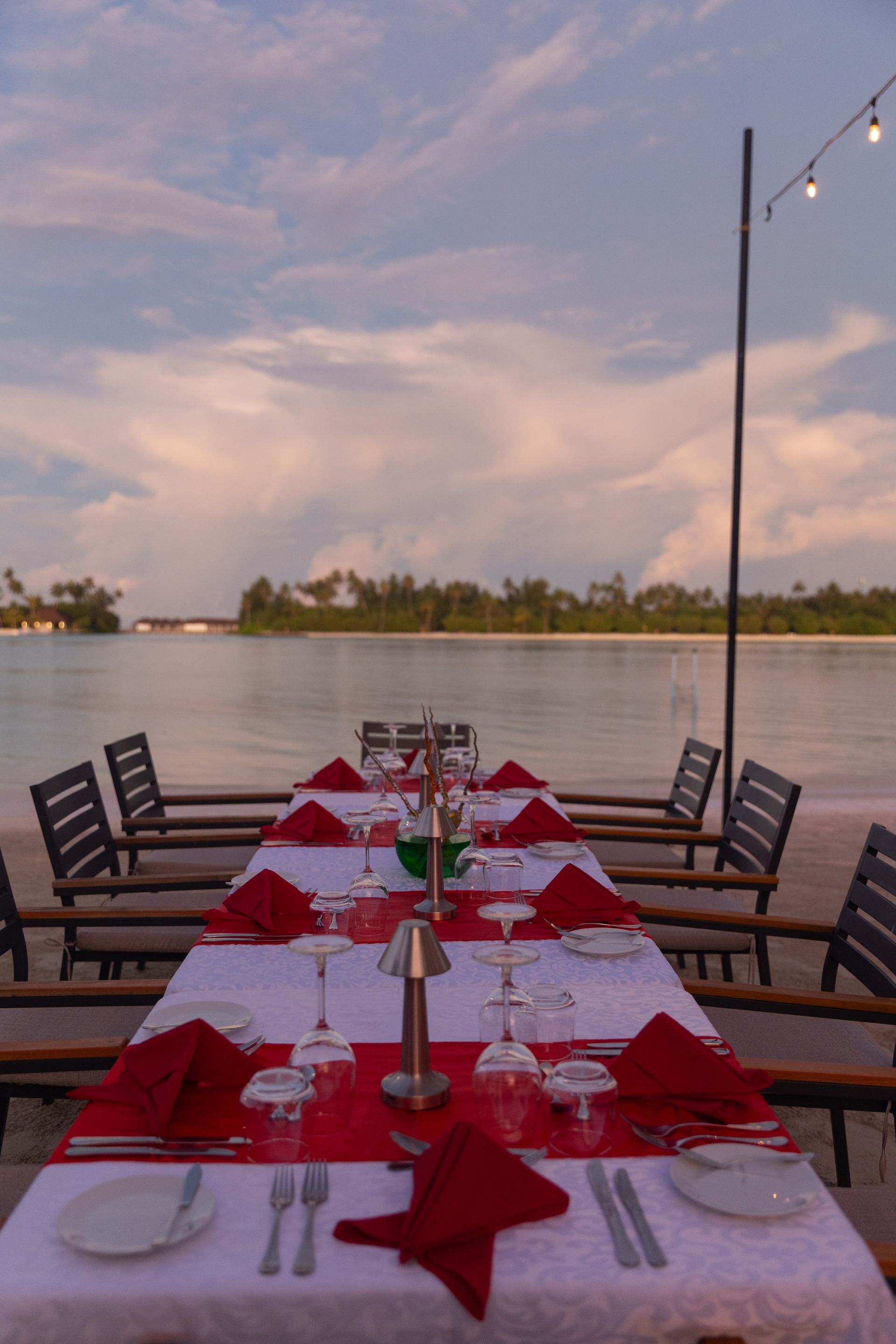 Elegant beachfront dining at sunset with scenic ocean view